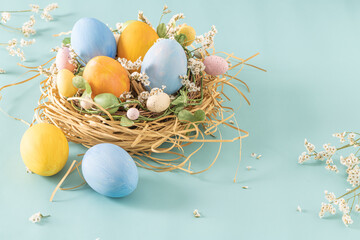 Easter blue and yellow eggs in nest