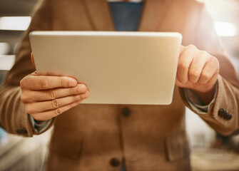 Digital design. Low angle shot of an unrecognizable male designer working on a tablet in his office.