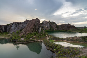 Fototapeta na wymiar Abandoned quarry with beautiful lake in mirror