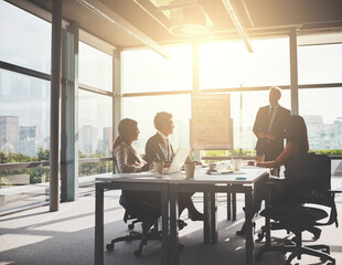 Strategizing is the key to success. Shot of corporate businesspeople having a meeting in the...
