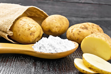 Starch potato in spoon on black board
