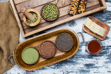 selection of healthy and clean food: seeds, superfoods, nuts, beans, juice, biscuits