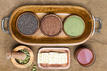 healthy food for healthy lifestyle: super green powder, Chia seeds and flax seeds in wooden bowls