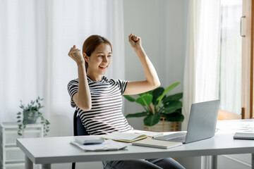 Business freelance Excited happy woman looking at the laptop screen, celebrating an online win working on laptop, smart female working at home, women relax after working at home concept.