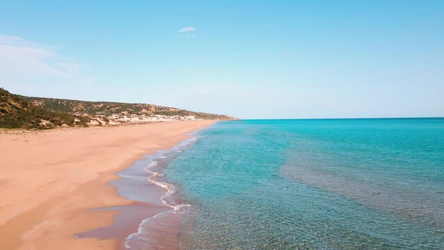 Aerial 4k Karpaz Golden Beach with crystal clear water and sandy coastline in North Cyprus, which offer you tropical exotic beach feeling with its natural untouched beauty in Cyprus Island.