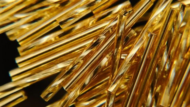 Bugle gold on a black background. Gold beads.Abstract geometric background in gold and black colors. Rotation. 4k footage