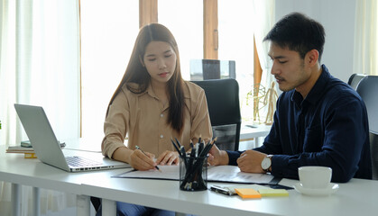 Young business people discussing over new business project in modern office.