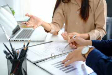 Cropped shot businesswoman explaining information with her colleague.