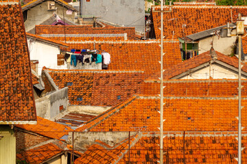 top view from the roofs of houses on the outskirts of Tegal, Indonesia, with a slightly cloudy sky background