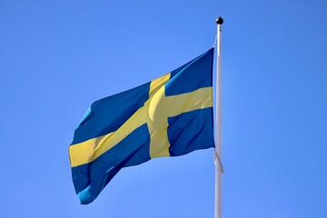 Sweden flag waving in strong wind on a sunny summer day