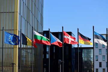 Group of EU memberstate flags waving in wind Court of Justice building in Luxembourg: EU, Belgium, Bulgaria, Czech Republic, Denmark, Germany, and Estonia