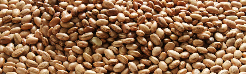Beans background. Brazilian grains carioca beans spread on the wooden table