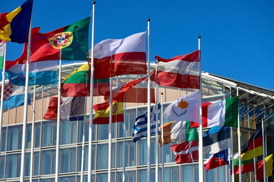 Group of EU memberstate flags flying in wind by EIB building in Luxembourg