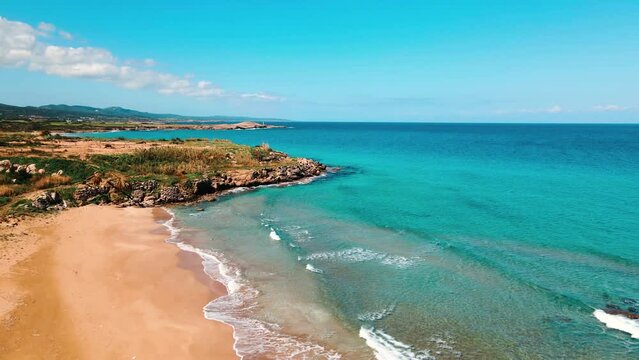 Aerial 4k Sandy Beach with crystal clear water and sandy coastline in North Cyprus, which offer you tropical exotic beach feeling with its natural untouched beauty in Cyprus Island.