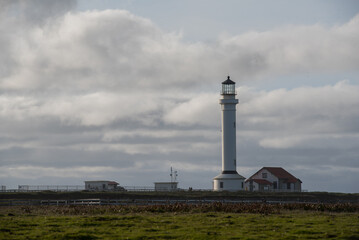 Fototapeta na wymiar Point Arena Lighthouse on the cliffs with stormy skies