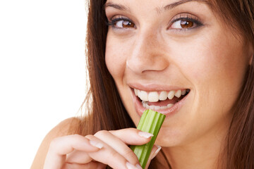 Eating healthy. Portrait of a beautiful young woman eating a stick of celery.