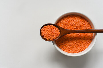 Raw lentil in bawl on white background