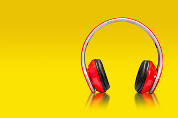 red headphone speaker, portable speaker  headphones on yellow background