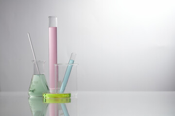 Front view of laboratory equipment filled with colorful fluid in a beaker test tube in lab...