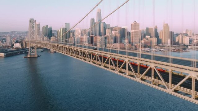 Aerial drone San Francisco City Skyline and Bay Bridge in gentle golden Sunrise