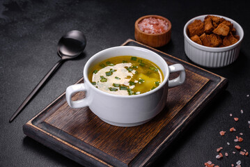 Fresh pea soup in bowl on black background. Cooking at home