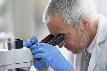 Finding advances in the small things. Shot of a scientific researcher at work on a microscope in a lab.