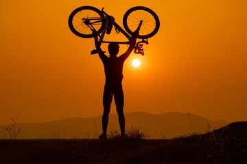 silhouette of a cyclist on sunset, the scenery sunrise in the morning in Thailand.