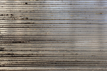 Fototapeta premium Close-up of a greenhouse wall made of old worn out dirty polycarbonate. Close up of old dirty roof polycarbonate