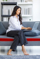 Asian young beautiful happy professional successful female businesswoman in casual outfit sitting...