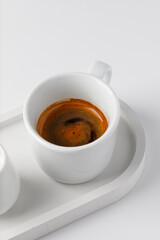 One cup with espresso or cappuccino on beton tray. Aroma, ristretto. Mug of coffee. White background. Modern. Close up