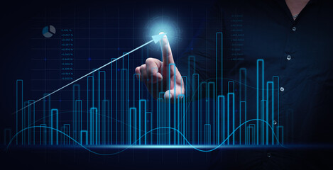man in a black shirt stands in front of a holographic graph with growing indicators. Business growth, sales increase. High performance