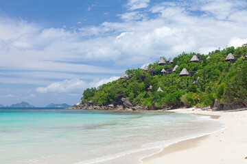 Fototapeta na wymiar Tropical beach with palm trees and sea