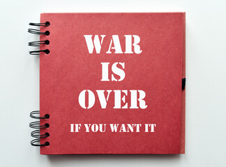 War is over, if you want it. Motivational quote on notebook paper.