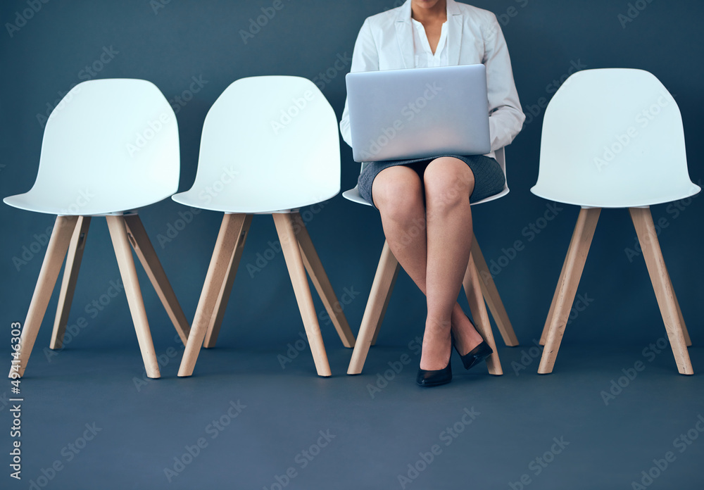 Leinwandbilder do some business while you wait. studio shot of an unrecognizable corporate businesswoman using a la
