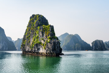 Scenic karst isle on blue sky background in the Ha Long Bay