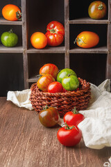 Colorful ripe tomatoes. Delicious vegetarian food. Dark background.