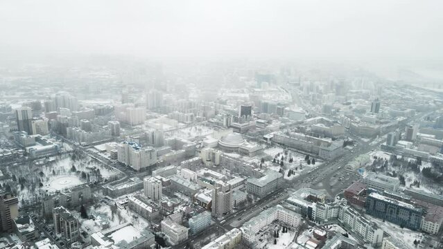 Aerial photography of a winter city. A city in Siberia in a blizzard.