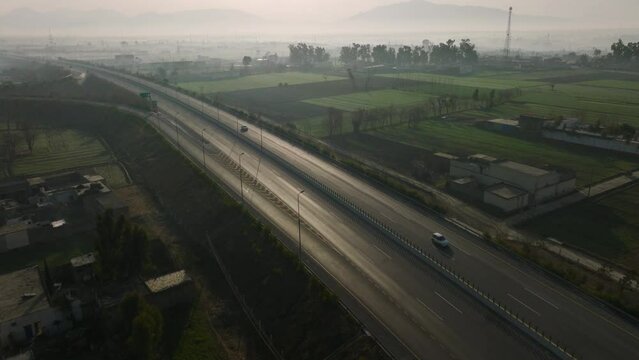 Aerial Over Hazara M 15 Motorway Through Rural Misty Landscape In Abbottabad. Dolly Back