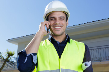 portrait of a builder on cellphone smiling