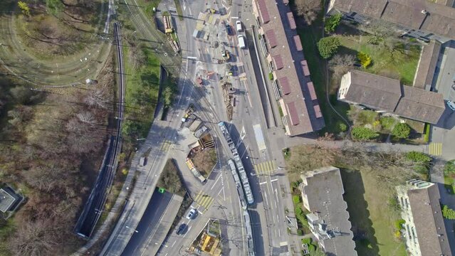 Aerial view of Milchbuck with streets, traffic, cars and trams on a sunny spring day. Movie shot March 21st, 2022, Zurich, Switzerland.