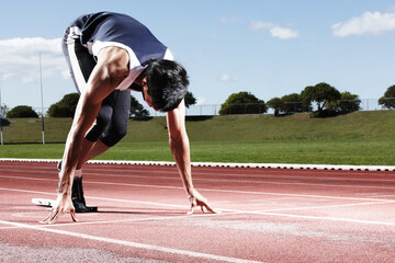 Ready to win this race. A young runner at the starting line.