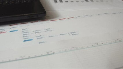 Top view with motion on charts and estimates. The concept of a workflow on a project in a pandemic and remote work