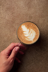 Cup of coffee cup in the hand top view