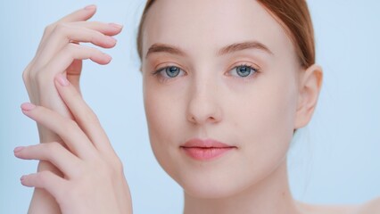 Obraz na płótnie Canvas Close-up portrait of young ginger woman demonstrates hands soft skin | Beauty and skincare commercial concept