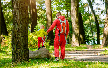 Father with her son walking in the summer Park
