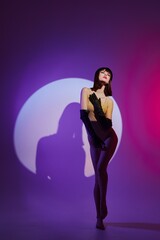 Fototapeta na wymiar glamorous woman scene spotlight posing neon studio model unaltered