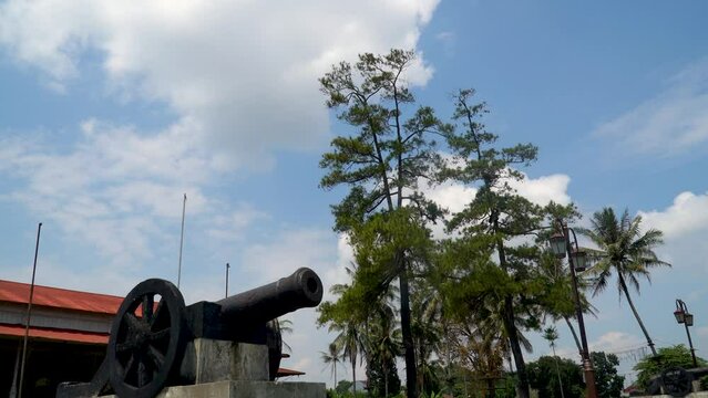 Old cannon from Dutch colonial era in Indonesia, pan down from sky