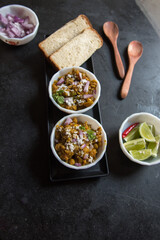 Popular Indian street food ghugni or yellow peas masala served in bowl. Top view.