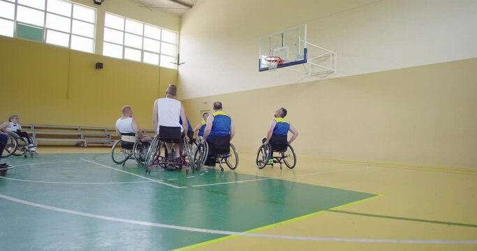 Persons with disabilities playing basketball in the modern hall