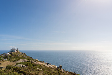 View of the cliff and lighthouse of Cape Finisterre, in Galicia, Spain. Tourism and travel concept.